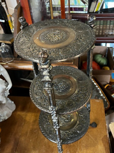 Antique Ornate Brass Three Tier Accent Table With Claw Feet And Bust Tops